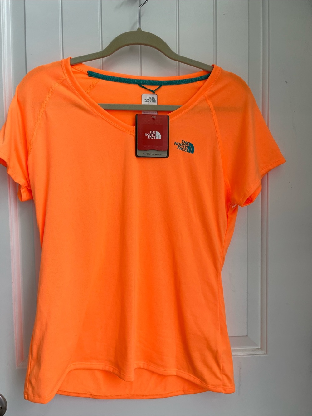 The North Face size Large womans performance tee shirt- tangerine with teal